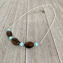 Load image into Gallery viewer, Tiger Ebony Necklace with Light Turquoise and Grey Crystals on a Silver Plated Chain