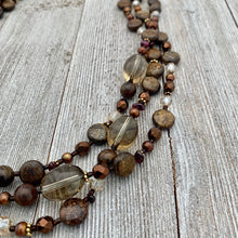 Load image into Gallery viewer, Three Strand Layered Necklace with Smoky Quartz, Bronzite, Bronze Fresh Water Pearls, Faceted Glass, 24k Plated Spacers, and Toggle Clasp