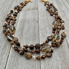 Load image into Gallery viewer, Three Strand Layered Necklace with Smoky Quartz, Bronzite, Bronze Fresh Water Pearls, Faceted Glass, 24k Plated Spacers, and Toggle Clasp