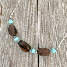 Load image into Gallery viewer, Tiger Ebony Necklace with Light Turquoise and Grey Crystals on a Silver Plated Chain
