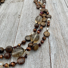 Load image into Gallery viewer, Three Strand Layered Necklace with Smoky Quartz, Bronzite, Bronze Fresh Water Pearls, Faceted Glass, 24k Plated Spacers, and Toggle Clasp
