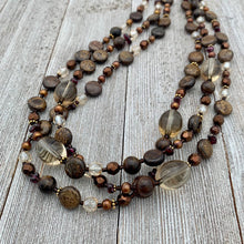 Load image into Gallery viewer, Three Strand Layered Necklace with Smoky Quartz, Bronzite, Bronze Fresh Water Pearls, Faceted Glass, 24k Plated Spacers, and Toggle Clasp
