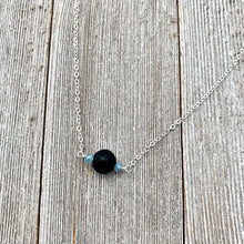 Load image into Gallery viewer, Black Lava Diffuser Necklace, Misty Blue Crystals, Silver Chain
